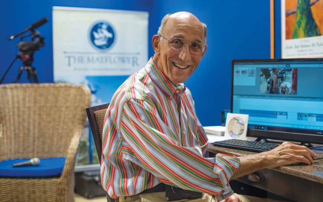 man sitting at a computer smiling
