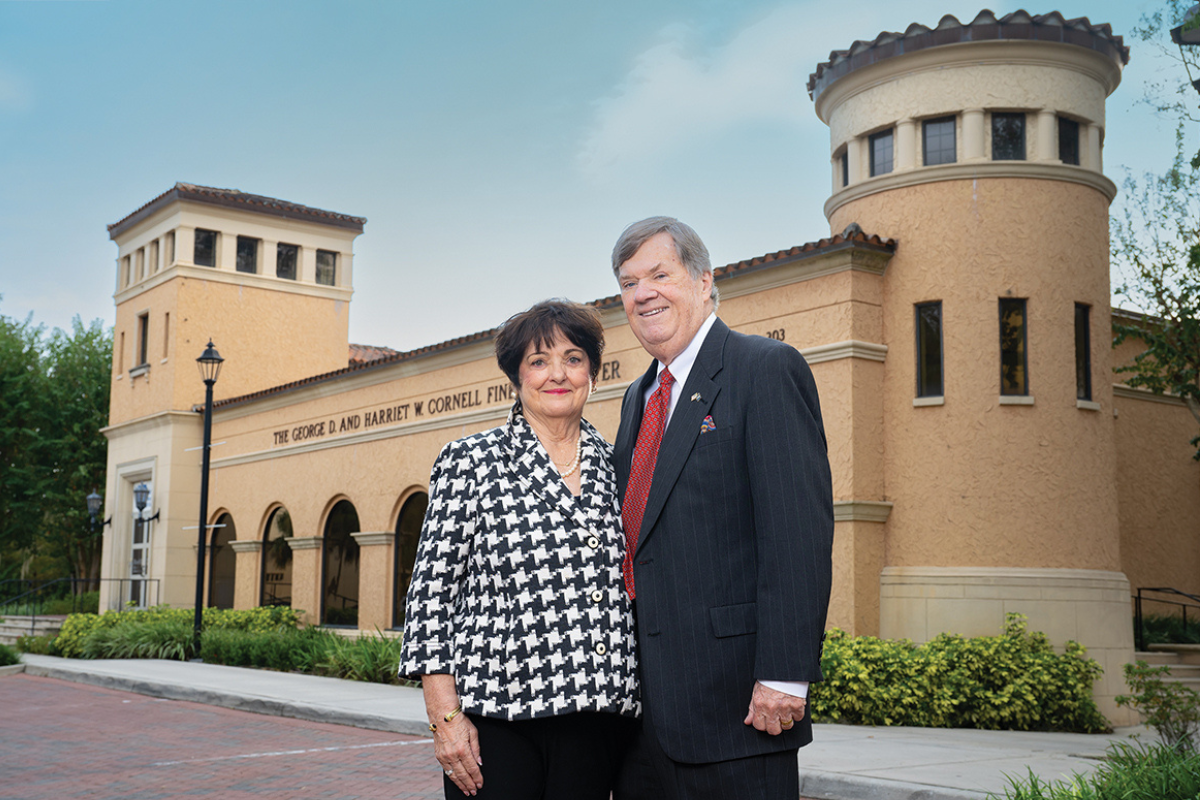 Senior couple stand in front of the Rollins Museum of Art in Winter Park, FL