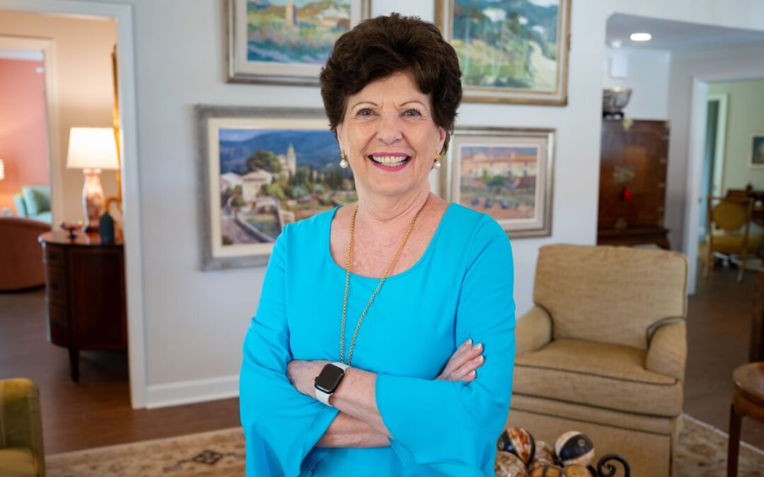 Susan Hamilton stands smiling in her beautiful home at The Mayflower.